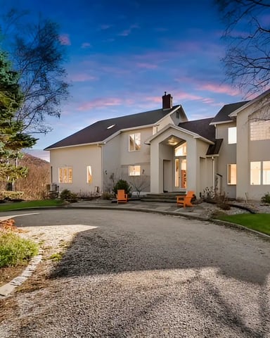 Exterior view of a beautiful large rental home under a clear sky.