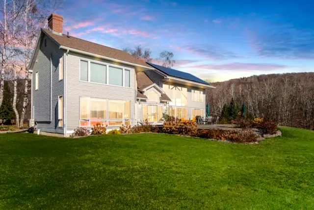 Exterior view of a beautiful large rental home under a clear sky.