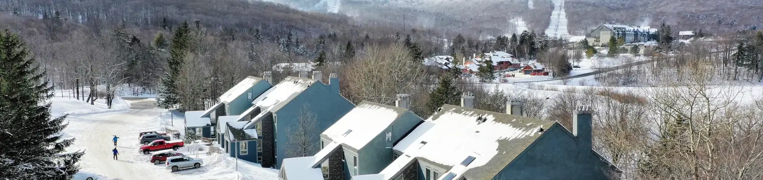 Exterior view of the Whiffletree condo complex with Killington Mountain seen in the background.