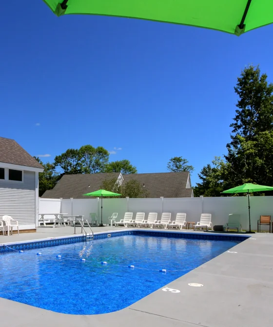 Outdoor pool at the common areas of the Killington Center Inn & Suites complex in Vermont, on a sunny day.