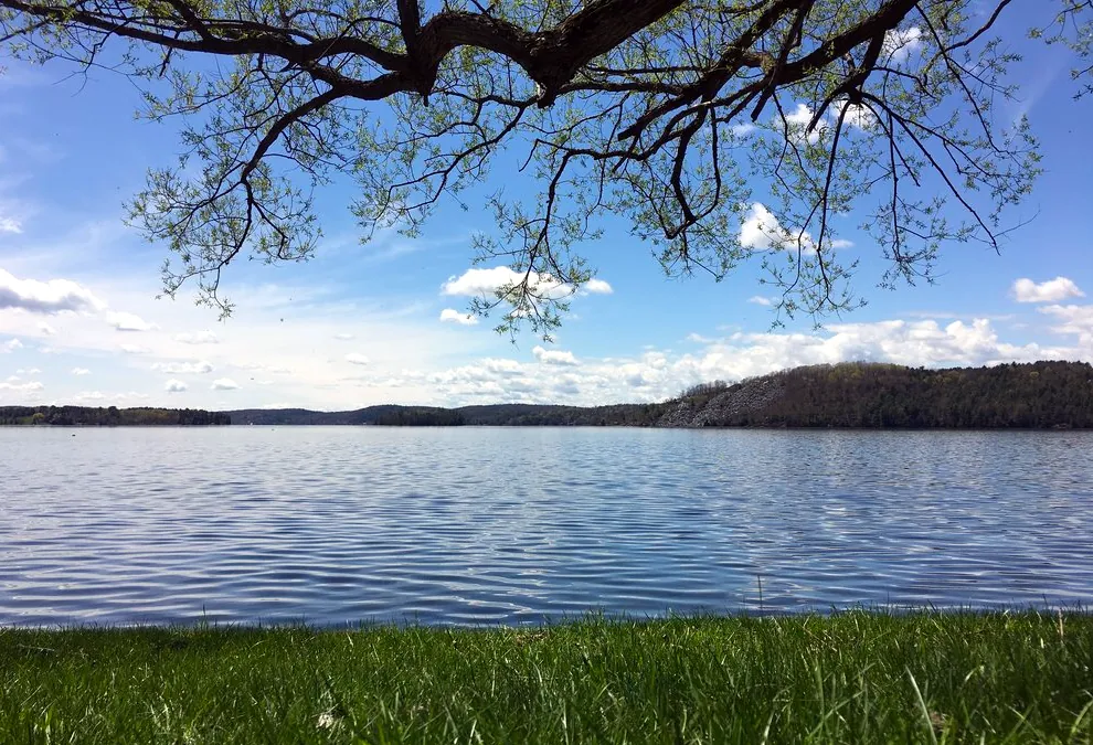 Panoramic view of a sunrise on Lake Bomoseen, VT, under a clear sky.